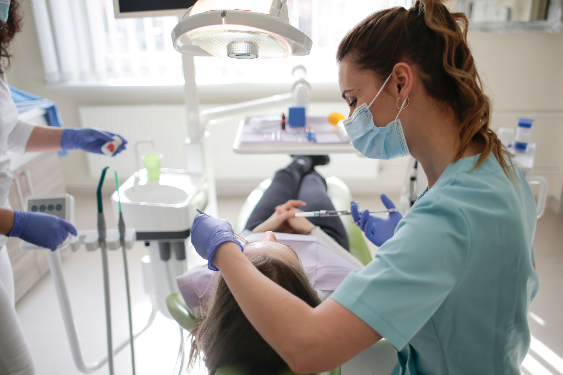 dental hygienist with patient